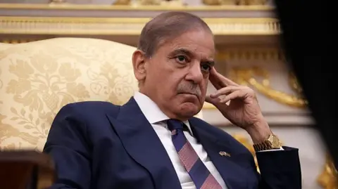 Getty Images Prime Minister of Pakistan Shehbaz Sharif looks on as US President Donald Trump speaks to reporters in the Oval Office of the White House on September 25, 2025.