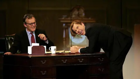 Dave Hogan/Getty Images Head sits behind a desk playing his character as the prime minister, while Walliams bangs on the table and makes an emotive face 