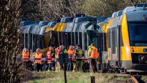 Reuters Two trains collided against each other as emergency services stand outside the crash.