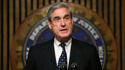 Getty Images Robert Mueller at a podium. He is dressed in a suit 