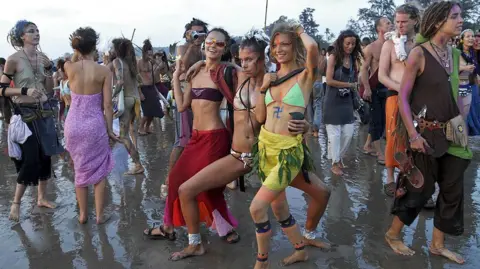 Getty Images Young travellers party on a Goa beach in 2006. 