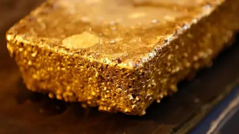 Bloomberg via Getty Images large bar of unrefined gold