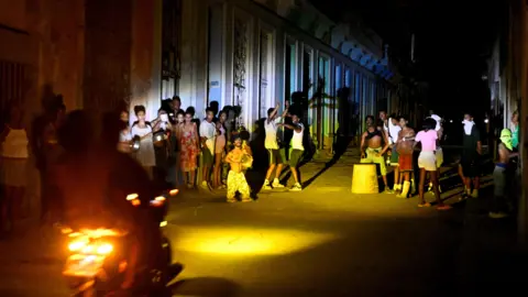 Reuters People gather on a street during a blackout as Cuba's national electric grid collapsed, according to the country's grid operator, 16 Mar 2026