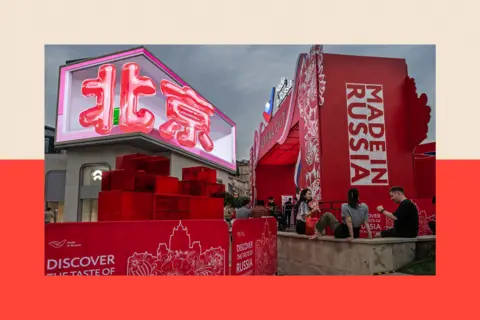 Getty Images The Chinese characters for Beijing are seen on a large screen at an event promoting Made In Russia goods and relations with China, at a shopping mall in Beijing, China 