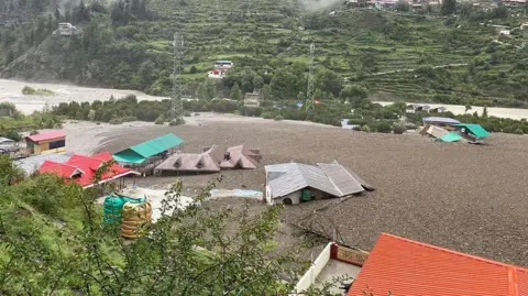 Getty Images A massive rescue operation is under way to locate around 100 missing people after a mudslide and flash floods triggered by a cloudburst struck a village of Dharali in Uttarakhand state, India on August 5, 2025.