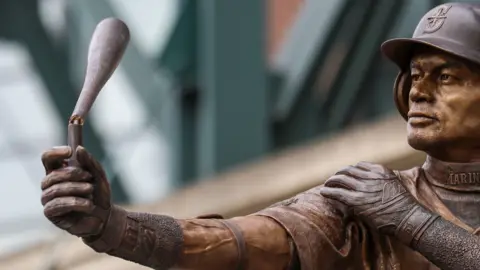 Getty Images The broken bat held by a statue of Ichiro Suzuki 