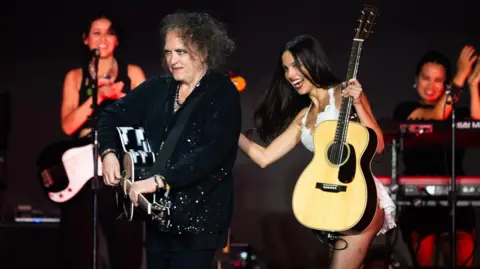 Getty Images Olivia Rodrigo and Robert Smith on the Pyramid Stage at the Glastonbury Festival, June 2025