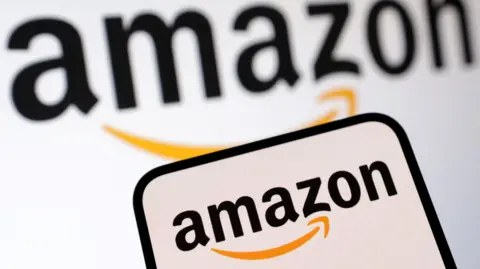 Reuters Amazon logo displayed on a smartphone screen, with a larger version of the company's logo on a white background behind it.