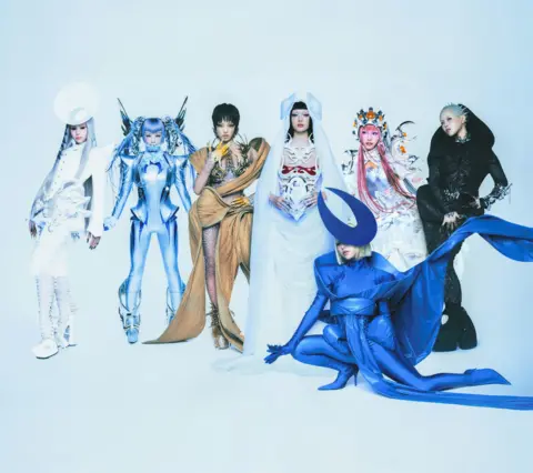XGALX The seven members of XG pose in a series of futuristic, semi-alien outfits in a promotional image for their album, The Core