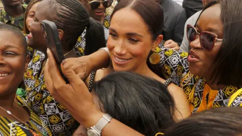 Emmanuel Osodi/Getty Images Women taken selfies with the Duchess of Sussex in Abuja, Nigeria - Saturday 11 May 2024