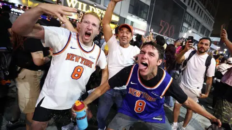 Getty Images New York Knicks fans celebrate outside Madison Square Garden after their team's Game 4 victory over the San Antonio Spurs in the NBA Finals in New York.