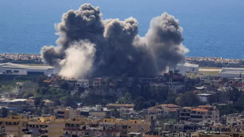 Reuters Smoke rises following an Israeli strike on the southern suburbs of Beirut. 