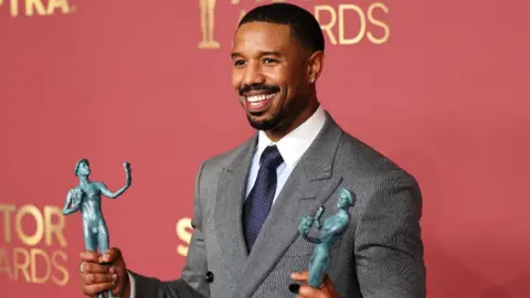 Reuters Michael B. Jordan poses with the Outstanding Performance By A Male Actor In A Leading Role award and the Outstanding Performance By A Cast In A Motion Picture award for 