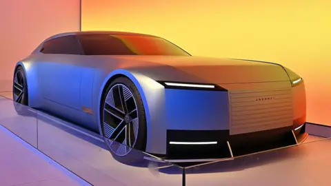 Getty Images A blue Jaguar Type 00 concept car is displayed at a car show