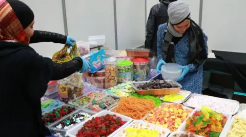 AFP Women prepare food during the 35th annual meeting of the French Muslim community on March 30, 2018 at Le Bourget, north of Paris.