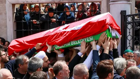 Reuters People carry the coffin of a victim of a school shooting during the funeral prayers at a mosque in Kahramanmaras, Turkey
