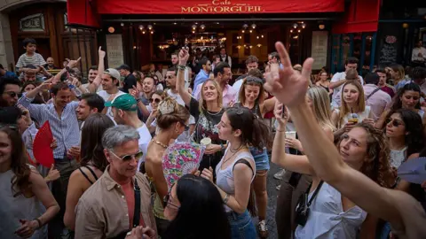 Getty Images Revellers dance in the street during Fete De La Musique 2025 as bands and DJs play on streets across the French capital.