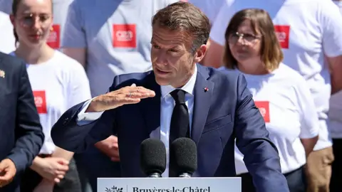 AFP via Getty Images France's President Emmanuel Macron gestures as he delivers a speech 