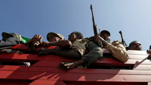 Reuters Armed Amhara fighters in khaki uniforms seen aboard a red truck