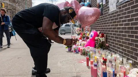 Getty Images A mourner ties balloons to a memorial and vigil where a 7-month-old baby, Kaori Patterson-Moore, was killed by a stray bullet on April 1 while sitting in her stroller in Brooklyn on April 04, 2026, in New York City.