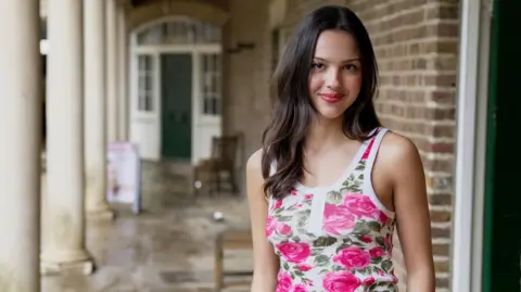 BBC/Josh Falcon Olivia Rodrigo poses outside The Old Kitchen of the 17th Century stately home, Kenwood House