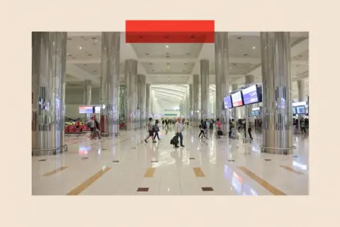 Getty Images Passengers walk inside of Dubai International Airport