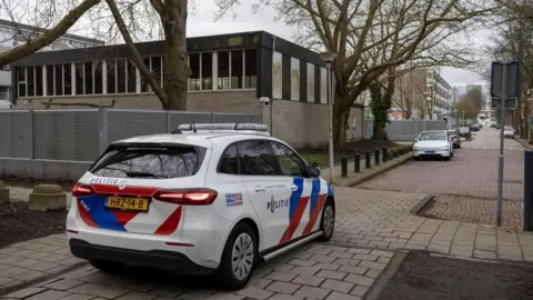 EPA/Shutterstock A police car is seen outside a Jewish school in Amsterdam, following an overnight explosion. Photo: 14 March 2026