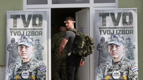 EPA A young man walks into an army barrack
