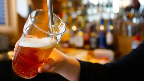 Getty A beer is poured in a bar