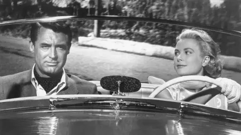 Paramount Pictures/Corbis via Getty Images American actors Cary Grant and Grace Kelly on the set of To Catch a Thief, directed and produced by British Alfred Hitchcock they are in a convertible car with Kelly at the wheel