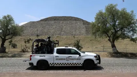 Reuters/Luis Cortes Members of the National Guard stand on a vehicle with the Pyramid of the Moon in the background, at the perimeter of the Teotihuacan pyramids after a gunman killed a Canadian woman and wounded several others before killing himself, authorities said, at one of the country's most visited tourist sites 