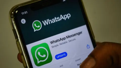 Getty Images In this photo illustration, a user updates Facebook's WhatsApp application on his mobile phone in Mumbai.