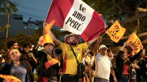 EPA A man holds a Peru flag reading 'te amo Peru'