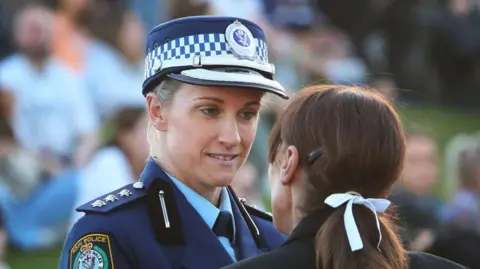 Getty Images Police officer Amy Scott speaks to a woman