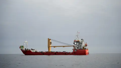 Reuters A vessel in the Strait of Hormuz, off the coast of Oman’s Musandam province, on 12 April