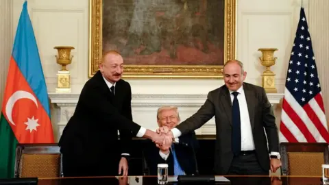 EPA L-R) Azerbaijan's President Ilham Aliyev, US President Donald Trump, and Armenia's Prime Minister Nikol Pashinyan join hands during a signing ceremony in the State Dining Room of the White House in Washington