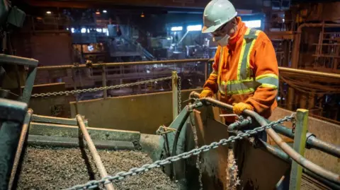 AFP via Getty Images An employee works in the Northern Graphite mine plant in Lac-des-Îles, Quebec