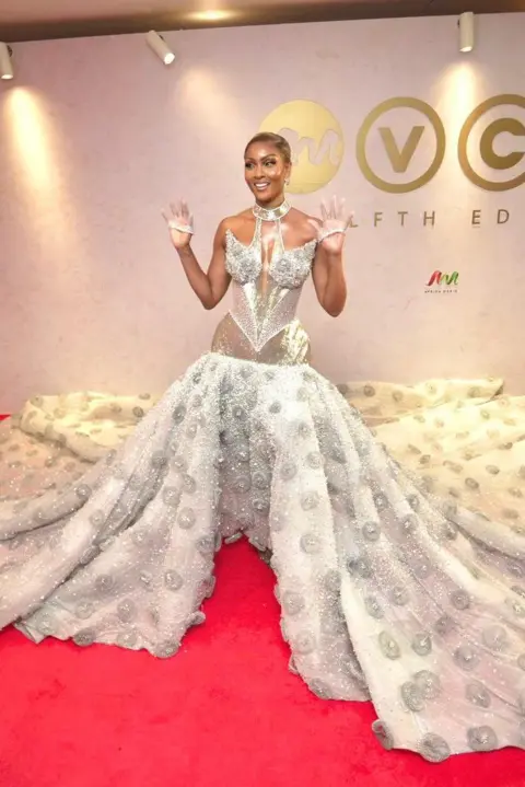 BBC/GIFT UFUOMA Osas Ighodaro is wearing a silver corset flowing dress embellished with hudreds of stones and crystals.