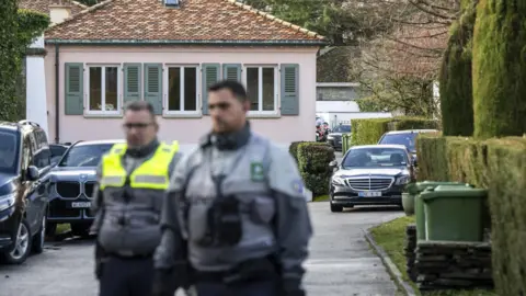 EPA Police officers stand guard outside of the Omani ambassador's residence in Geneva, Switzerland, during indirect nuclear talks between the United States and Iran (17 February 2026)