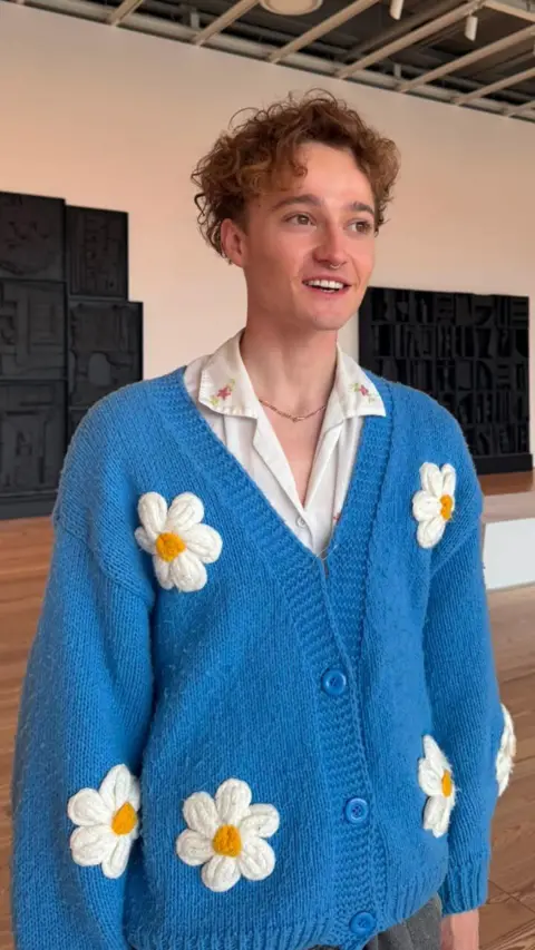 Handout James Marshall, in a white shirt and blue cardigan with embroidered daisies.