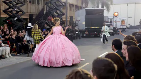 Getty Images Model Grace Elizabeth wearing a very large pink dress walks the runway during Vogue World Hollywood