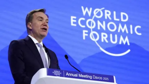 Reuters Borge Brende speaking on stage at Davos in January. He is wearing a suit and standing in front of a background which says