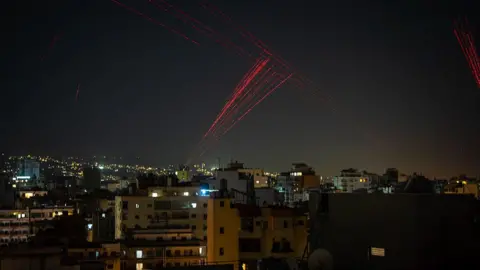 Getty Images Gunfire is fired into the sky from Beirut's southern suburbs in the early hours of April 17, 2026, as residents celebrate the start of a 10-day ceasefire that took effect at midnight. 