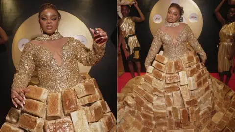 BBC/GIFT UFUOMA Reality TV star Queen Mercy Atang is seen with her dress made from loaves of bread