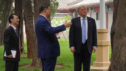 Getty Images US President Donald Trump and Chinese President Xi Jinping tour the Zhongnanhai leadership compound on May 15, 2026 in Beijing, China. 