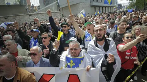 Anadolu via Getty Images Citizens stage a protest against the decisions of High Representative for Bosnia and Herzegovina, Christian Schmidt in Sarajevo, Bosnia and Herzegovina on April 28, 2023. Schmidt announced on the night of the general elections on Oct. 2, he had enacted a controversial electoral law reform, using the "Bonn powers." 