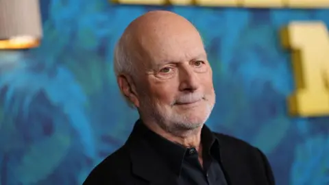 Getty Images James Burrows in a short white beard and mustache and a dark suit looks slightly away from the camera. 
