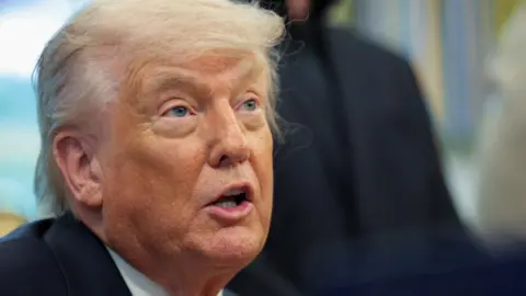 Reuters A close-up shows Donald Trump talking, while looking serious.