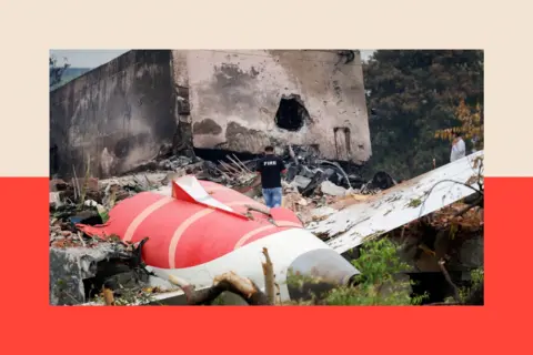 Reuters A firefighter stands next to the crashed Air India Boeing 787-8 Dreamliner aircraft