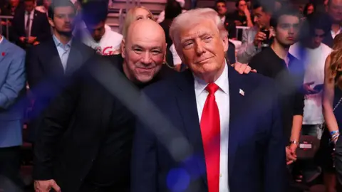 Zuffa LLC via Getty Images Trump and Dana White standing beside each other and smiling in front of a crowd